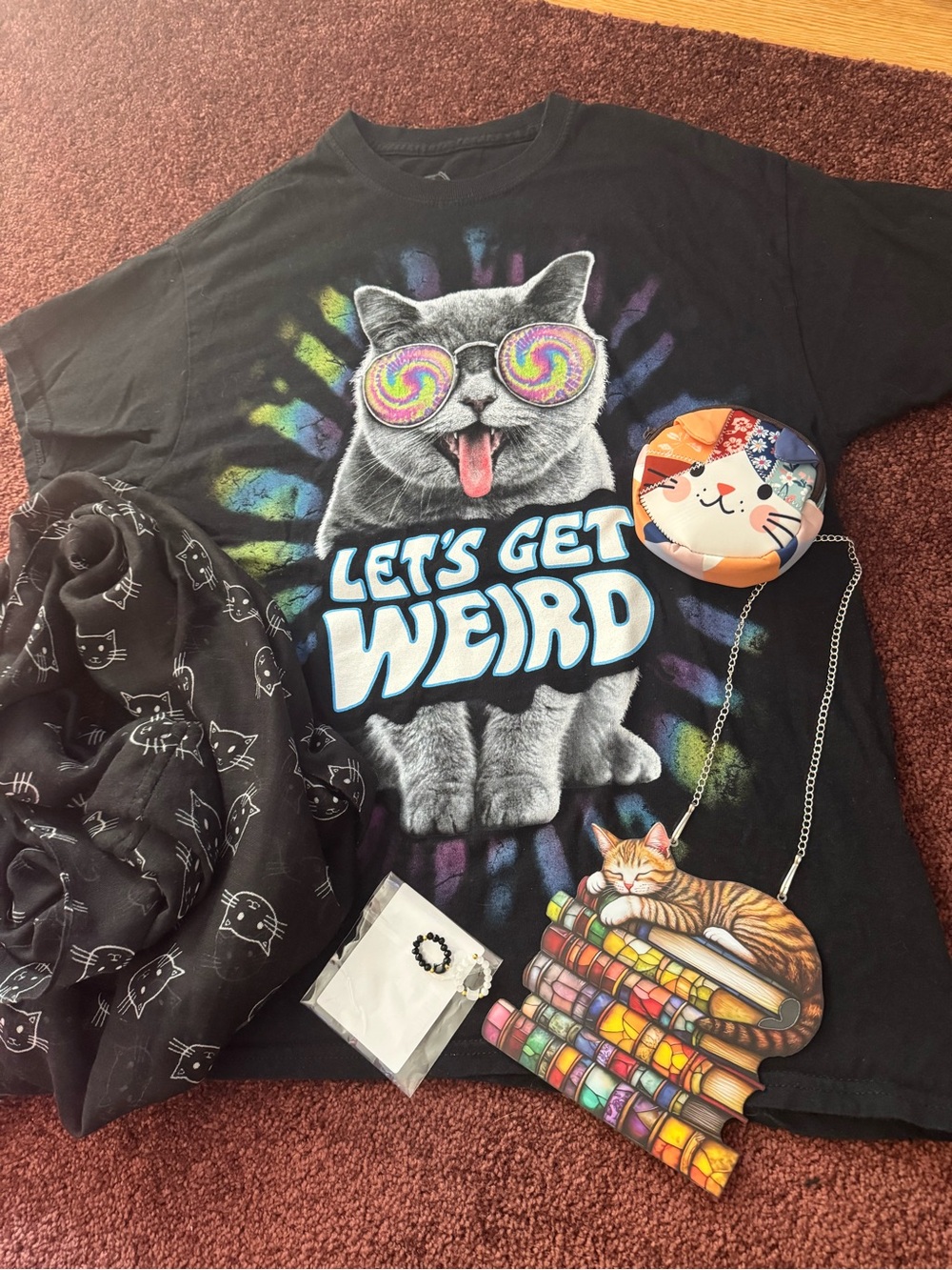 Cat graphic tshirt, friendship rings, suncatcher, coin pouch, and scarf
